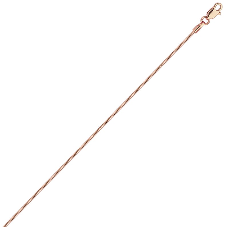 May include: A rose gold snake chain necklace. The chain is thin and delicate.