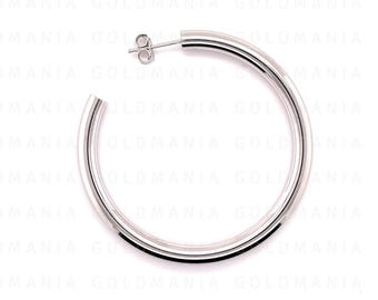 May include: A single, polished silver hoop earring. The earring is a simple, circular design with a smooth, reflective surface. The post is visible at the top, and the earring is set against a white background. The earring is a classic jewelry piece.