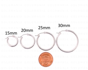 May include: Four silver hoop earrings of different sizes, 15mm, 20mm, 25mm, and 30mm, are displayed on a white background. A penny is placed below the earrings for size comparison.