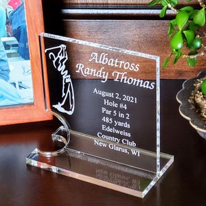 May include: A clear acrylic plaque with a golfer silhouette and the text "Albatross Randy Thomas"  "August 2, 2021 Hole #4 Par 5 in 2 485 yards Edelweiss Country Club New Glarus, WI"