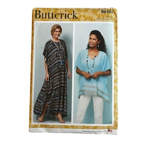 May include: Butterick sewing pattern envelope B6559 for sizes LRG-XLG-XXL. The front displays two garment options: a long black kaftan with a white geometric pattern and a light blue short-sleeved top with a decorative hem and V-neckline.