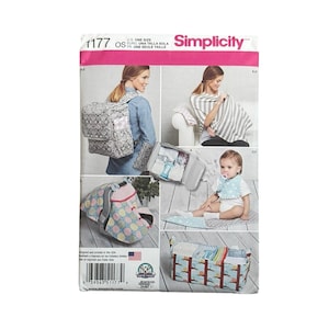 May include: Simplicity pattern 1177 for baby accessories. The envelope displays a gray patterned backpack, a striped nursing cover, a polka dot car seat canopy, a baby bib, and a rectangular storage caddy with a colorful owl print pattern.