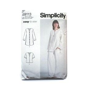 May include: A Simplicity S9113 easy-to-sew pattern envelope for sizes 16-24. The front displays a white long-sleeved tunic and pants set, with line drawings of two variations including a short-sleeved version. The text includes S9113, U5, and Simplicity.