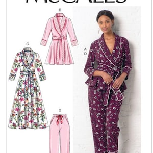 May include: McCALL'S M7875 sewing pattern envelope featuring illustrations of a robe and pajama set. Designs include a short pink robe, a long floral robe, and a dark purple floral pajama set with a wrap top and matching trousers with white piping.