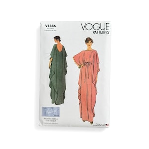 May include: Vogue Patterns sewing pattern featuring two long dresses. The pattern cover shows illustrations of the dresses in green and pink. The pattern is a reissue of a 1979 design. The Vogue Patterns logo is at the top.