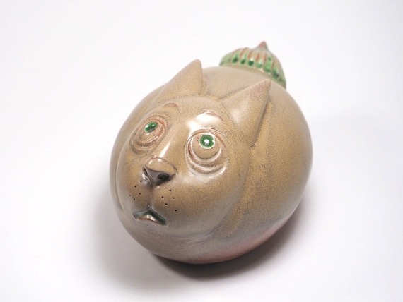 A handmade ceramic rabbit sculpture with an intentionally 'off' folk-art strangeness — not cute-shop bunny, but genuinely odd in the best way.
