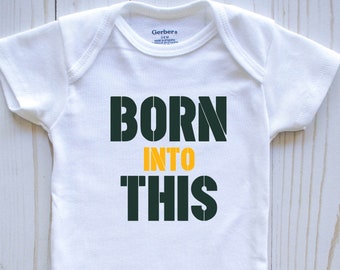May include: White baby onesie with green and yellow text that reads "Born into this".