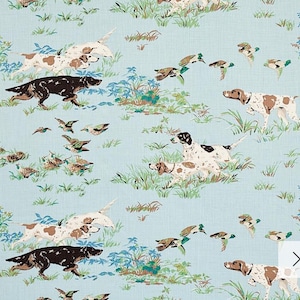 May include: A blue and white fabric with a repeating pattern of brown and white dogs, ducks, and birds. The dogs are running and the ducks are flying. The fabric has a light blue background.