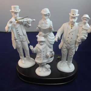 Porcelain Christmas Carolers With music box Base