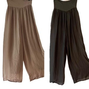 May include: Two pairs of wide-leg pants, one in a light brown color and the other in black. Both pants have a loose, flowing fit and a high waist.