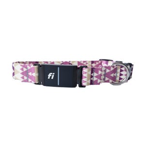 May include: A pink and white patterned dog collar with a black and silver tracker that says "fi" on it.