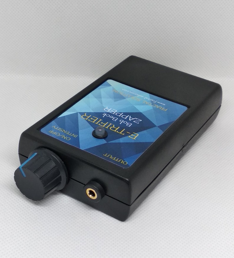 May include: Black electronic device labeled "E-TRIFIER Bob Beck ZAPPER" with a blue and white geometric design. Features a knob labeled "ON/OFF INTENSITY" and an output jack. The device is rectangular with rounded edges.