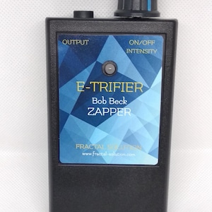 May include: Black rectangular device labeled "E-Trifier Bob Beck Zapper" with a blue and white geometric design. It has a black knob, a small button, and the text "Output" and "On/Off Intensity". The website www.fractal-solution.com is also visible.