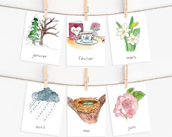 May include: Six watercolor illustrations of months of the year, each with a different image. January shows a snowy tree, February shows a cup of tea and a heart, March shows daffodils, April shows a rainy cloud, May shows a bird's nest, and June shows a pink rose.