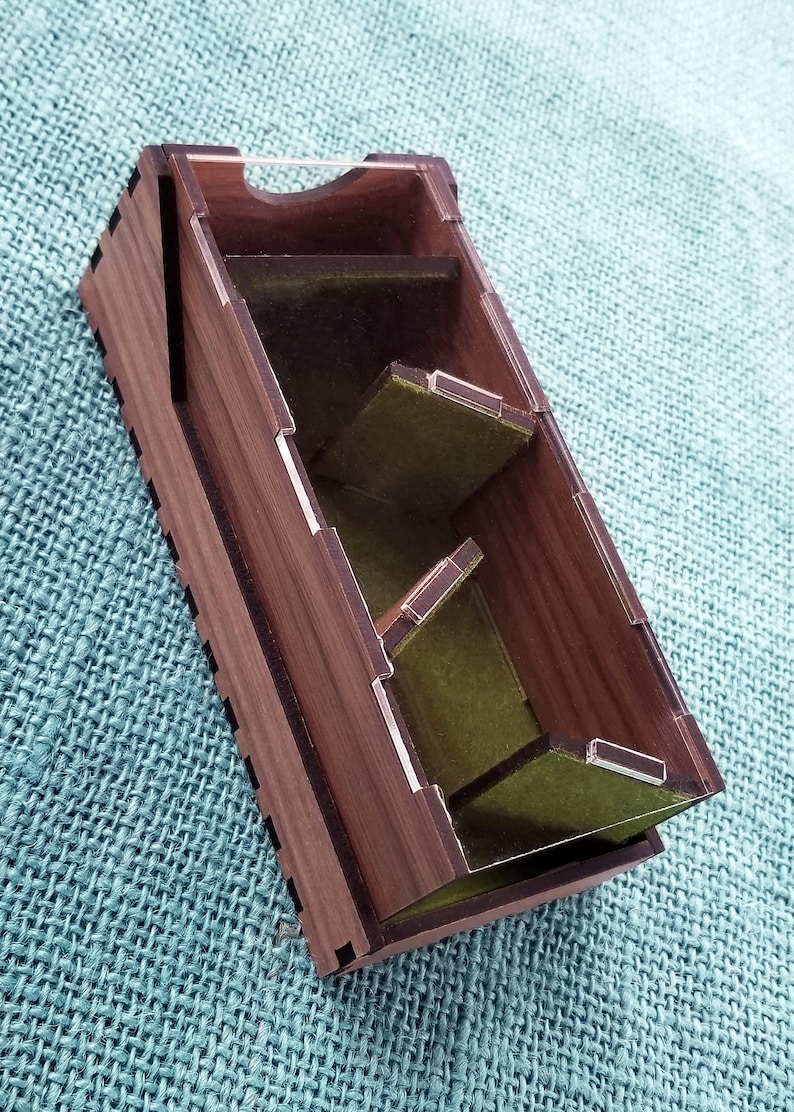 May include: A wooden box with a clear acrylic lid and green felt lining. The box has multiple compartments for organizing small items.