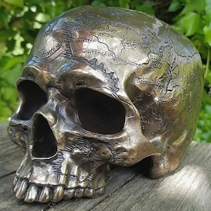 Ancient map skull, pirate treasure map, bronze human skull