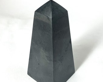 Può includere: Una punta di piramide di ossidiana nera, un tipo di cristallo utilizzato nella guarigione e nella meditazione.