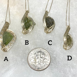 May include: Four silver wire wrapped green aventurine pendants, labelled A, B, C, and D. A U.S. dime is included for size comparison.