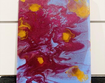 May include: Abstract acrylic painting on canvas. The artwork features a blend of colours, including shades of red, yellow, and blue. The paint is swirled and layered, creating a unique and textured appearance. The canvas is rectangular and mounted on a wooden frame.