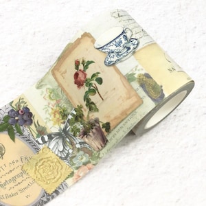 May include: Decorative washi tape featuring a collage of vintage-style images. The tape includes illustrations of a rose, butterfly, teacup, and botanical elements. The color palette is soft, with cream, beige, and pastel tones. The tape is ideal for scrapbooking and crafting.