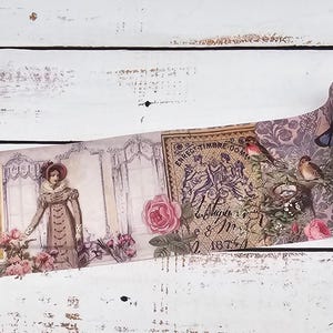May include: A roll of decorative adhesive tape featuring a repeating pattern of vintage-style illustrations, including a person in period clothing, pink roses, birds, and ornate script text on a muted purple and cream background with floral motifs.