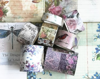 May include: Assortment of decorative washi tapes with floral, bird, and dragonfly designs. The tapes are in various colors, including pink, purple, blue, and green.