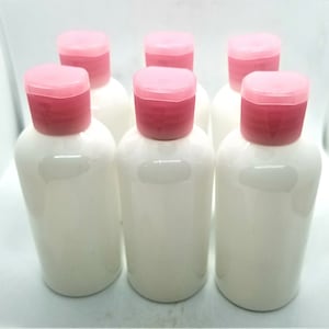 Refillable Round Bottles with Flip Top Caps - 2 oz (White). Pack of 6 bottles and cap.