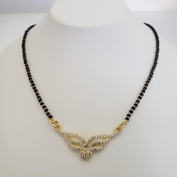 black beads with south sea pearls | Gold mangalsutra designs, Black beads  mangalsutra design, Black beaded jewelry