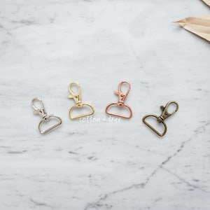 May include: Three metal swivel clasps in silver, gold, and bronze.