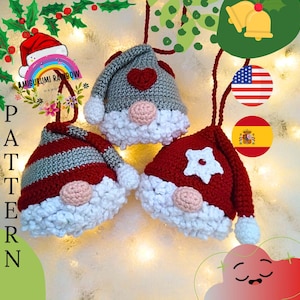 May include: Three crocheted gnome ornaments with red and white hats, each with a different design on the front. The gnomes are hanging from a string with a small American flag and a Spanish flag.