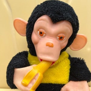 Old stuffed monkey with banana in hand hotsell