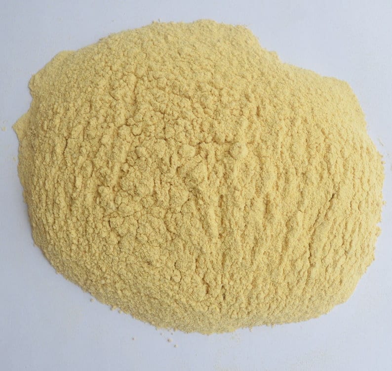 May include: A close-up of a pile of yellow cornmeal.