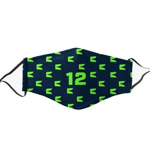 May include: Navy blue face mask with a repeating pattern of green stylized letter 'E' shapes. The number '12' is prominently displayed in green. The mask has black adjustable ear loops and white lining.