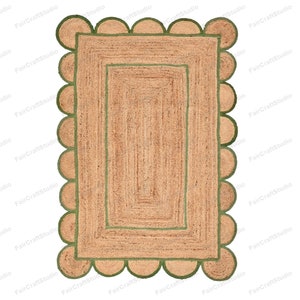 May include: A rectangular jute rug with a green border and scalloped edges. The rug has a smaller green rectangle in the center.