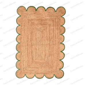 May include: A rectangular jute rug with a scalloped border in a green color. The rug has a woven pattern with multiple layers of jute.