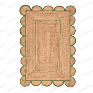 May include: A rectangular jute rug with a green border and a scalloped edge. The rug has a double border with a smaller green border inside the larger green border.