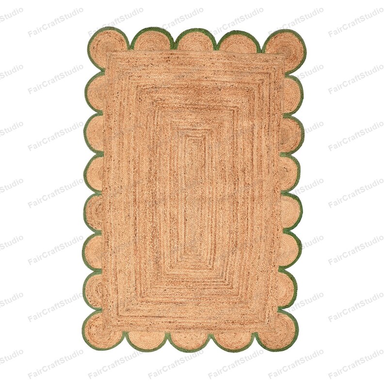 May include: A rectangular jute rug with a scalloped border in a green color. The rug has a woven pattern with a subtle texture.