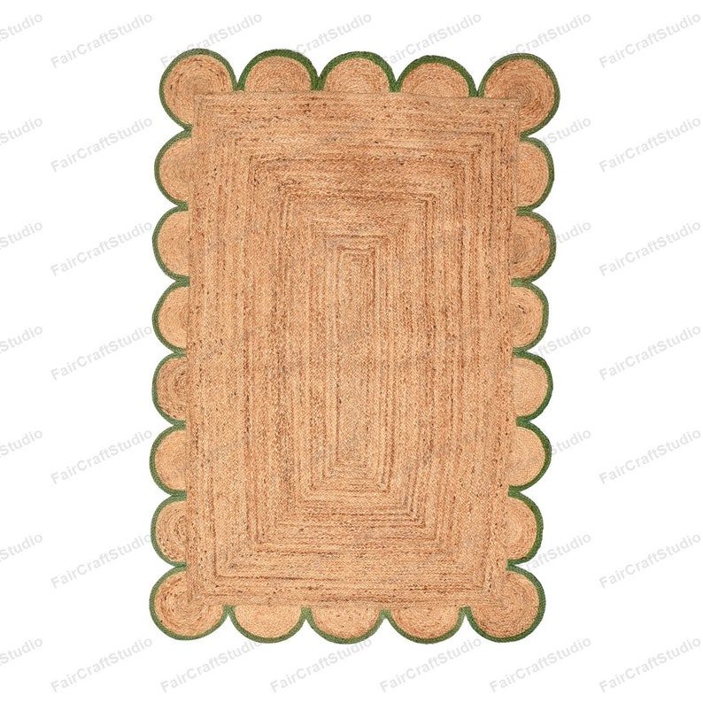 May include: A rectangular jute rug with a scalloped border in a green color. The rug has a woven pattern with a subtle texture.
