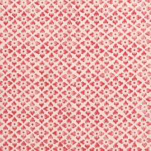 May include: A close-up of a fabric featuring a repeating pattern of red floral motifs on a cream background. The design is arranged in a diamond grid, creating a textured appearance. Suitable for textiles or home decor.