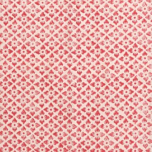 May include: A close-up of a fabric featuring a repeating pattern of red floral motifs on a cream background. The design is arranged in a diamond grid, creating a textured appearance. Suitable for textiles or home decor.