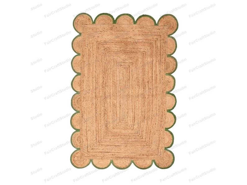 May include: A rectangular jute rug with a scalloped border in a green color. The rug has a woven pattern with multiple layers of jute.