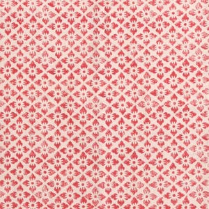 May include: A close-up of a fabric featuring a repeating pattern of red floral motifs on a cream background. The design is arranged in a diamond grid, creating a textured appearance. Suitable for textiles or home decor.