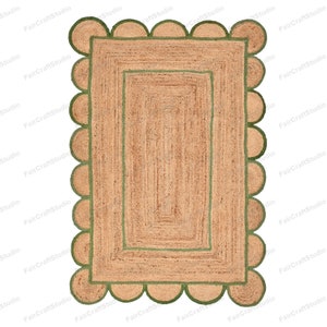 May include: A rectangular jute rug with a green border and a scalloped edge. The rug has a woven texture and a natural brown color.