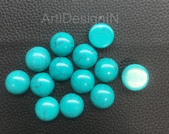 May include: A collection of 13 turquoise cabochons, each with a unique marbled pattern. The cabochons are round and have a smooth, polished finish.