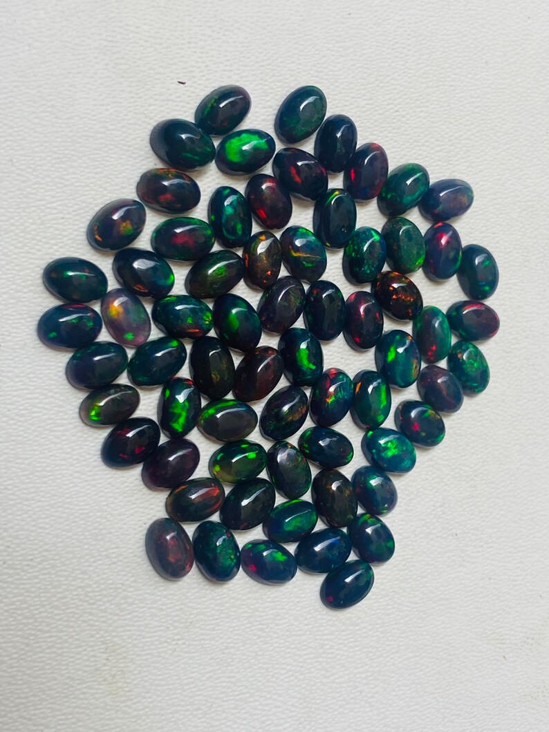 Gema ovalada de ópalo negro natural AAA, piedras sueltas de calidad AAA+. imagen 3