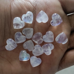 May include: A collection of 14 iridescent white heart-shaped moonstone crystals.