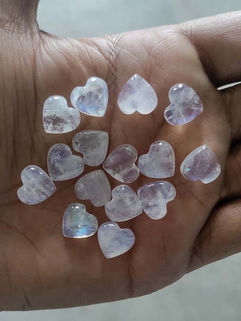 May include: A collection of 14 iridescent white heart-shaped moonstone crystals.