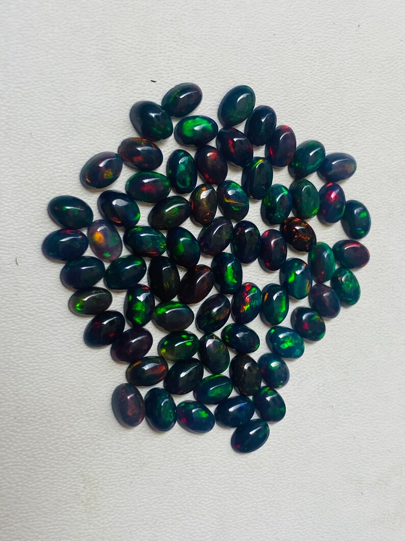 Gema ovalada de ópalo negro natural AAA, piedras sueltas de calidad AAA+. imagen 7
