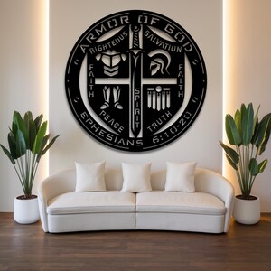 May include: Black metal wall art featuring the words "Armor of God" in a circular design. The design includes a sword, helmet, and other symbols, with the text "Righteous, Salvation, Faith, Peace, Truth, Ephesians 6:10-20".