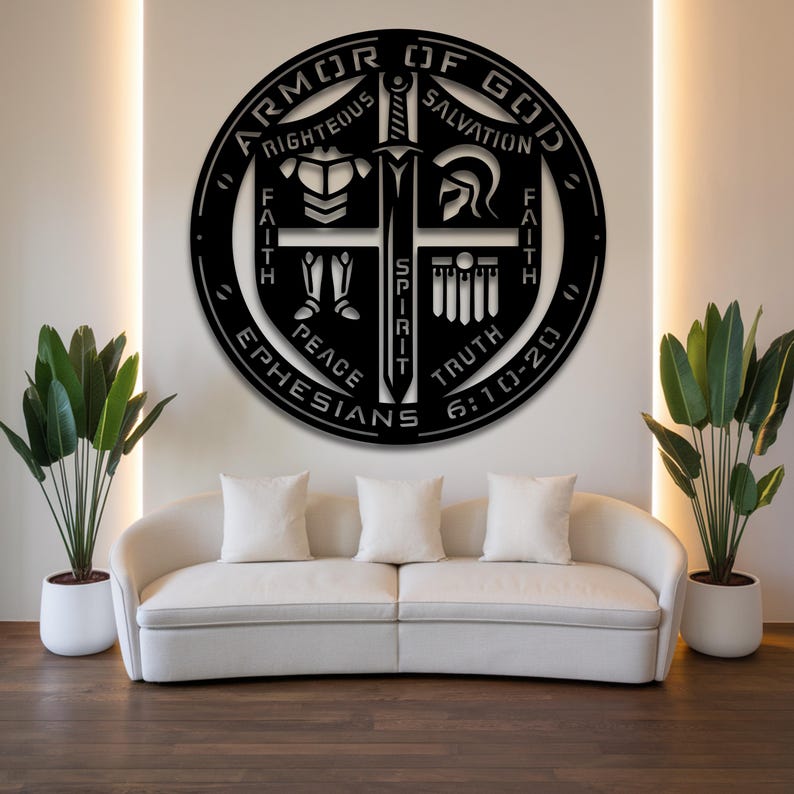 May include: Black metal wall art featuring the words "Armor of God" in a circular design. The design includes a sword, helmet, and other symbols, with the text "Righteous, Salvation, Faith, Peace, Truth, Ephesians 6:10-20".
